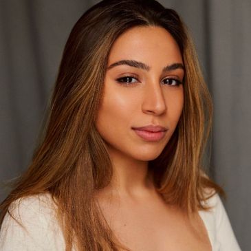 Portrait of a woman with long brown hair and natural makeup.
