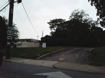 Image of a driveway with an upside-down DO NOT ENTER sign. 