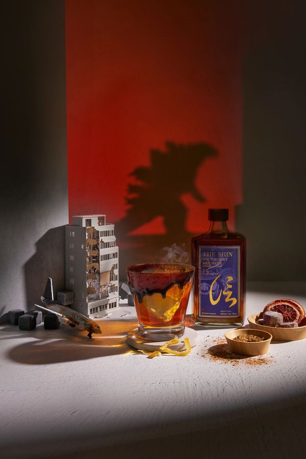 Whiskey with Godzilla shadow and city ruins.
