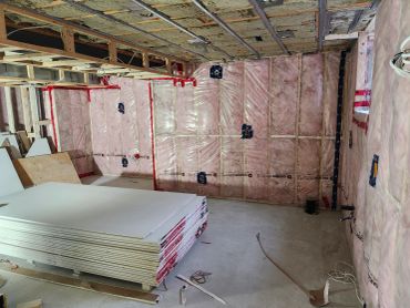 Room insulated and prepared for drywall installation.