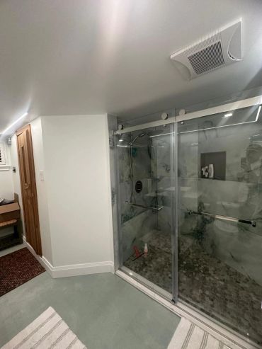Modern bathroom with glass shower enclosure.