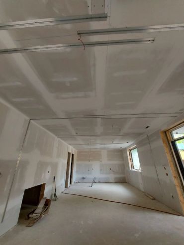 Interior room under construction with drywall.