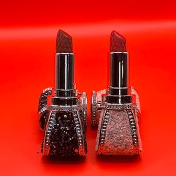 Two luxury lipsticks with gemstone-like textures and jeweled cases.