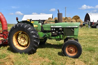 Green tractor on a farm field.