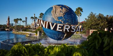 Iconic Universal Studios globe with clear blue sky.