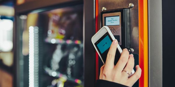 a woman paying at a vending machine