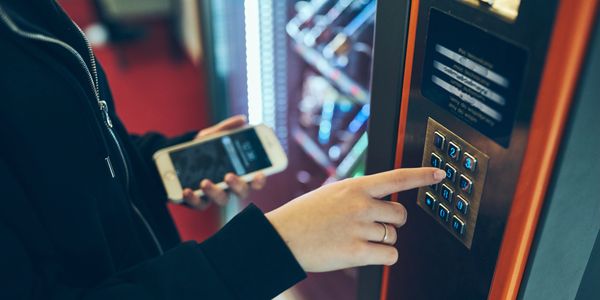 a woman using a vending machine