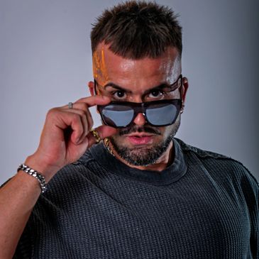 Man with sunglasses and a confident expression.