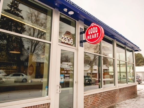 Exterior of Good Heart café with large windows and a red circular sign.