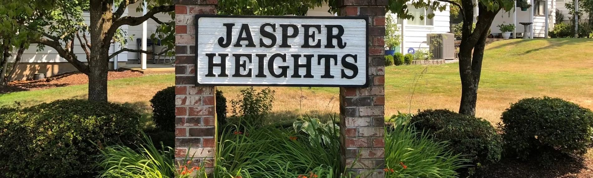 Brick signpost with 'Jasper Heights' in a landscaped neighborhood.