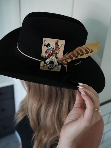 Cowboy hat, playing card, feather