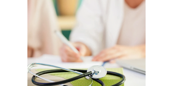 picture of stethoscope in the foreground of a healthcare provider