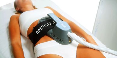 woman receiving emsculpt treatment