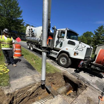 vacuum truck excavating around underground pipe