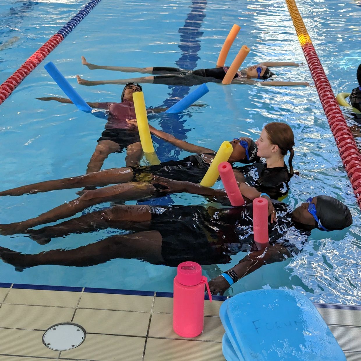 A group of women having swimming lessons. 