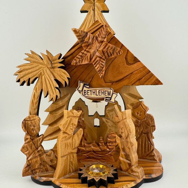 Wooden Bethlehem nativity scene with carved figures and star.