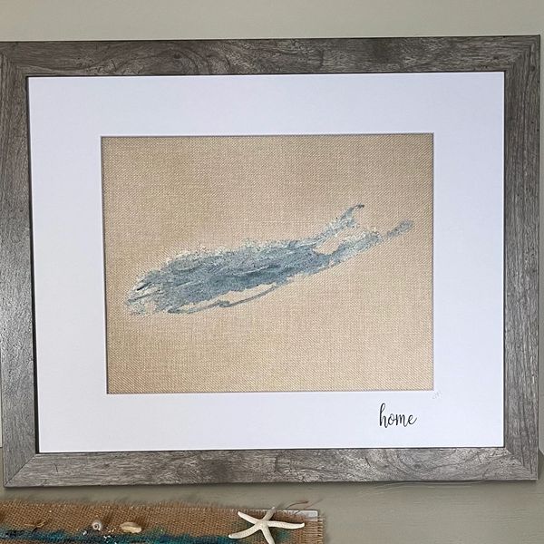 Framed minimalist art with textured blue brushstroke and 'home' inscription.