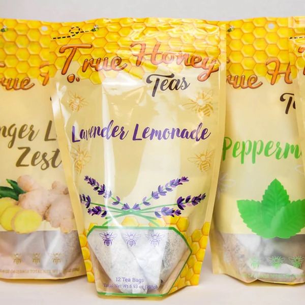 Assorted True Honey Teas in colorful packaging with honeycomb design.
