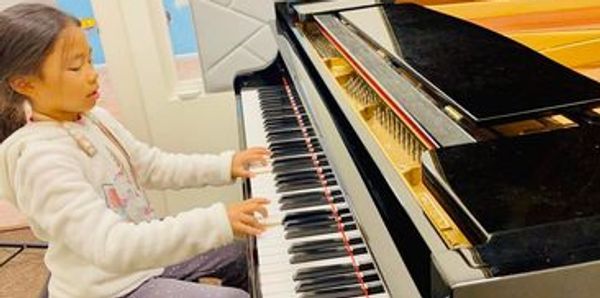 kid playing piano