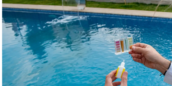 Testing pool water with a chemical kit.