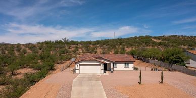 Single-story house in a desert landscape.