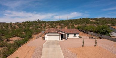 Single-story house in a desert landscape.