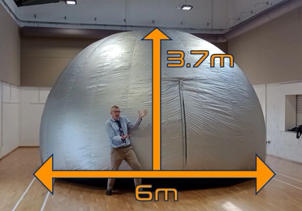 A man stands beside a large inflatable dome measuring 6m wide and 3.7m tall.