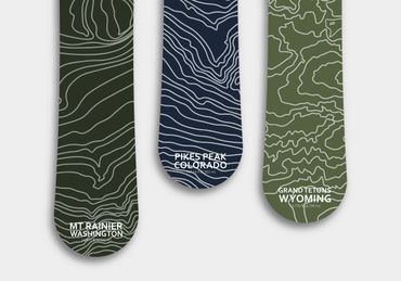 Snowboard designs with topographical maps of some US mountain ranges.
