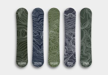 Snowboard designs with topographical maps of some US mountain ranges. 