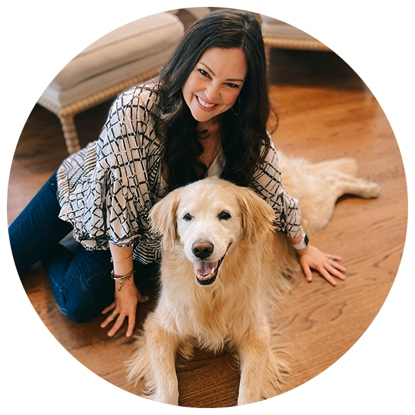 a woman with a dog sitting on the floor 