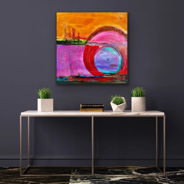 Colorful abstract painting hung above a modern console table.