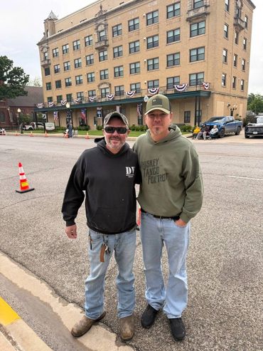 Veterans meeting in Texas during the Medal of Honor Parade celebrating brotherhood and patriotism.