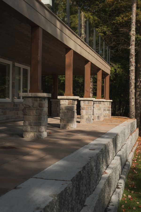 Stone pillars supporting a wooden porch roof.