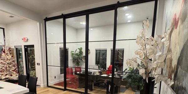 Modern office with glass walls and Christmas tree.