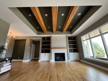 Modern living room with wood beams and fireplace.