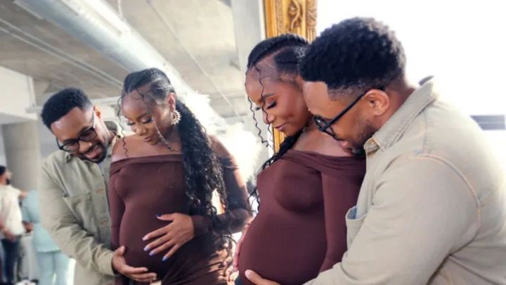 Couple joyfully admiring the pregnant belly together.