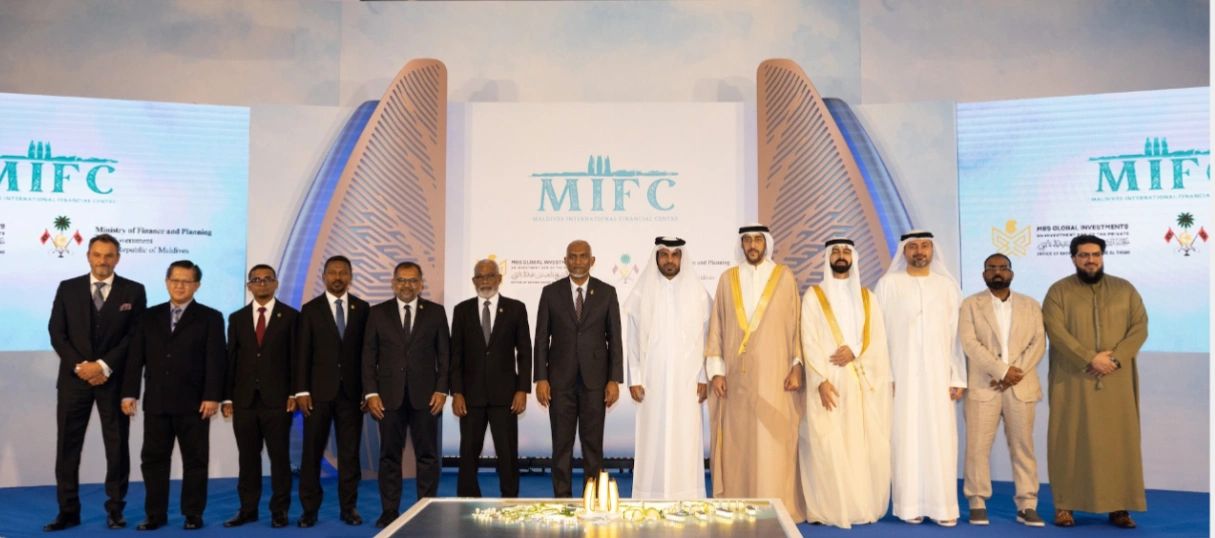 Group photo of men in suits and traditional attire at MIFC event.