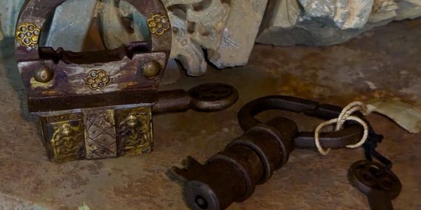 Richly decorated handcrafted lock and key shaped artisanal lock.
