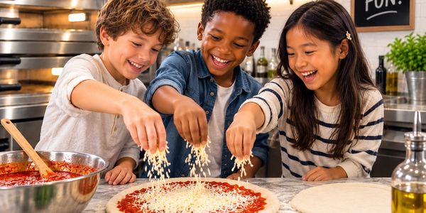 Three children happily making pizza together.