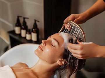 Woman relaxing while getting her hair washed.