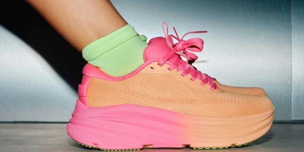 Stylish pink and peach sneakers with lime green socks.