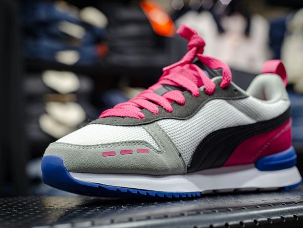 Colorful running shoe with pink laces.