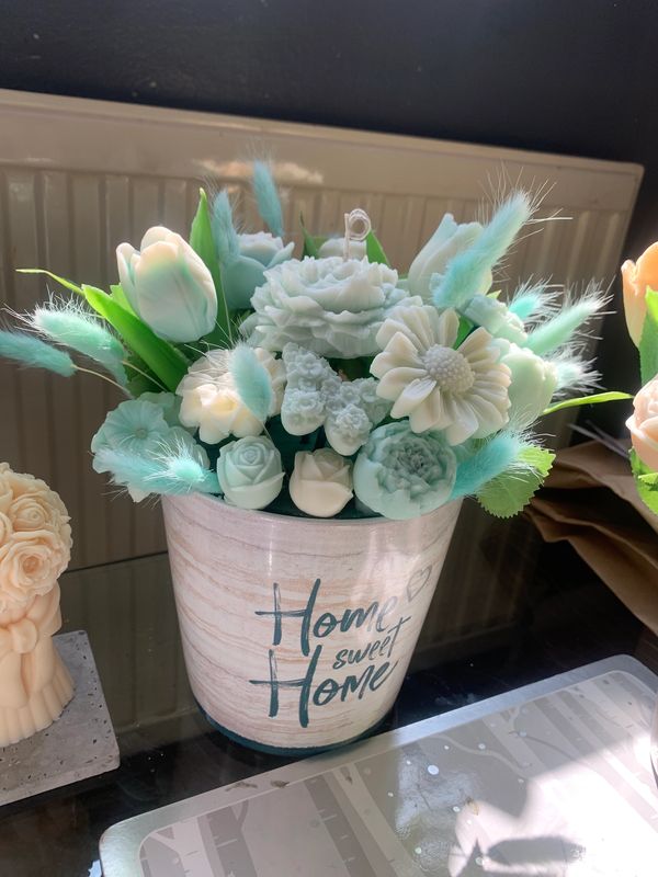 Decorative potted candle and wax melt bouquet in teal and white flower arrangement in a pot with 'Home sweet Home' text.