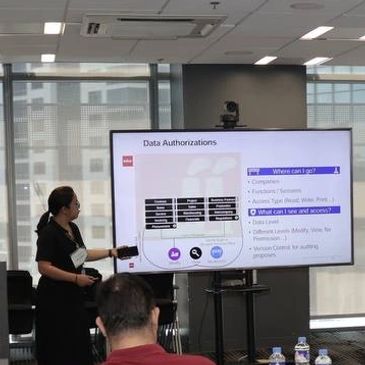 Woman presenting data authorizations on a screen in a conference room.
