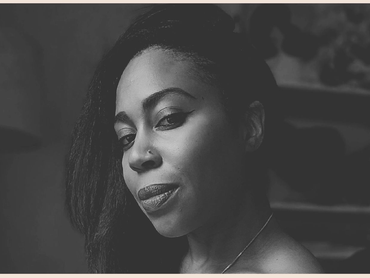 Black and white portrait of a woman with a nose ring.