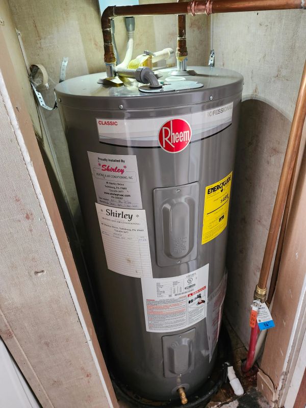 Rheem water heater installed in utility closet.