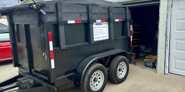 Image of a dumpster rental at customers home to dispose of waste removal