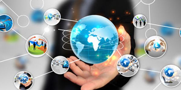 Businessman holding a glowing digital globe connected to multiple network icons.