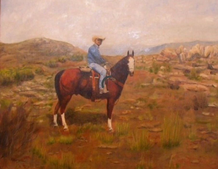 Cowboy on horseback in a desert landscape.
