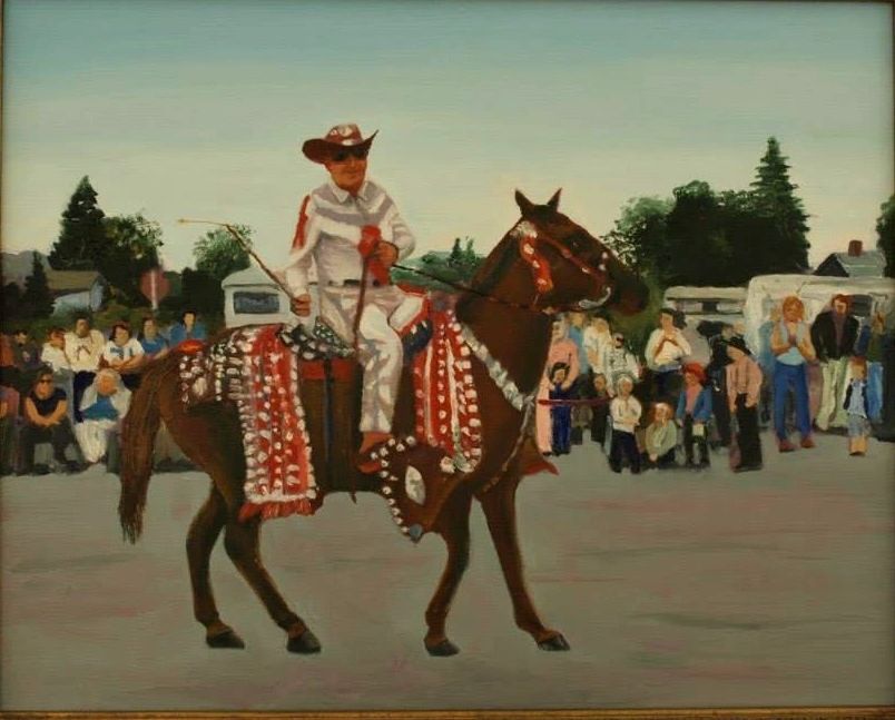 Man in white cowboy outfit riding a decorated horse in front of crowd.